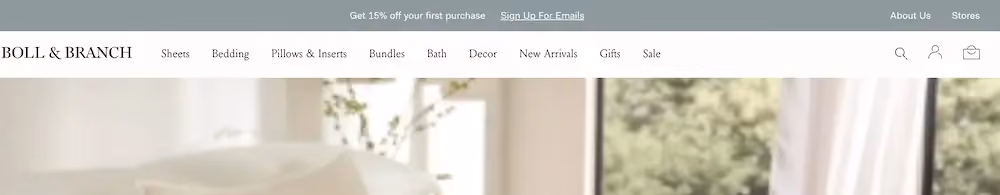 Sticky bar on Boll & Branch's home page offering 15% off as an incentive to sign up for emails.