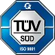 A blau-weißes TÜV SÜD Siegel in achteckiger Form mit Text ISO 9001 in der unteren Leiste