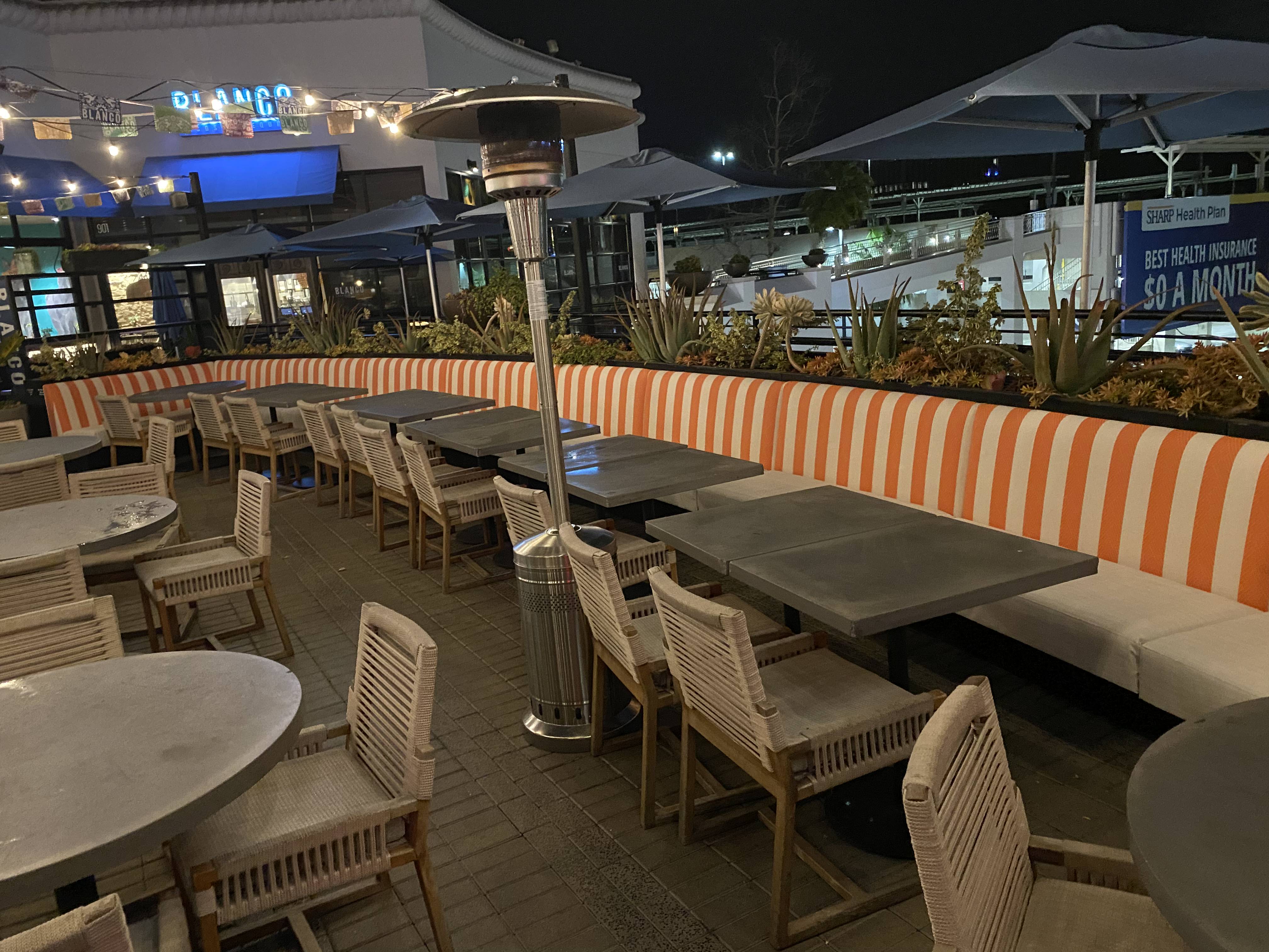 Cracked, worn restaurant booth vinyl before recover by Manilla Upholstery