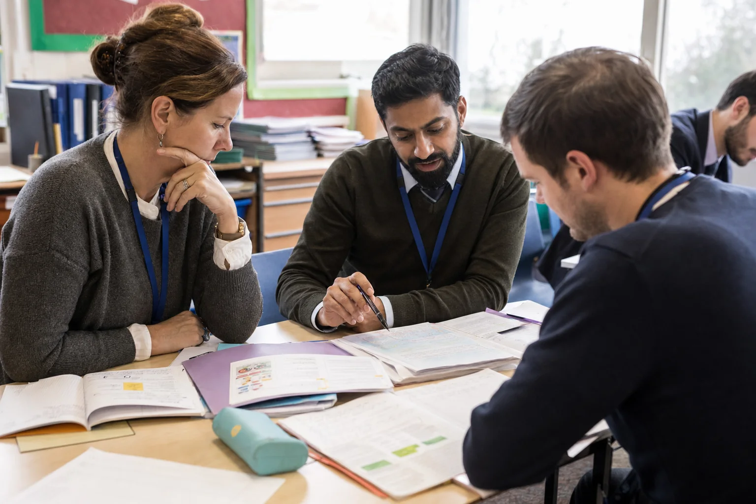 Teachers plan and review a lesson collaboratively in a teacher planning setting.