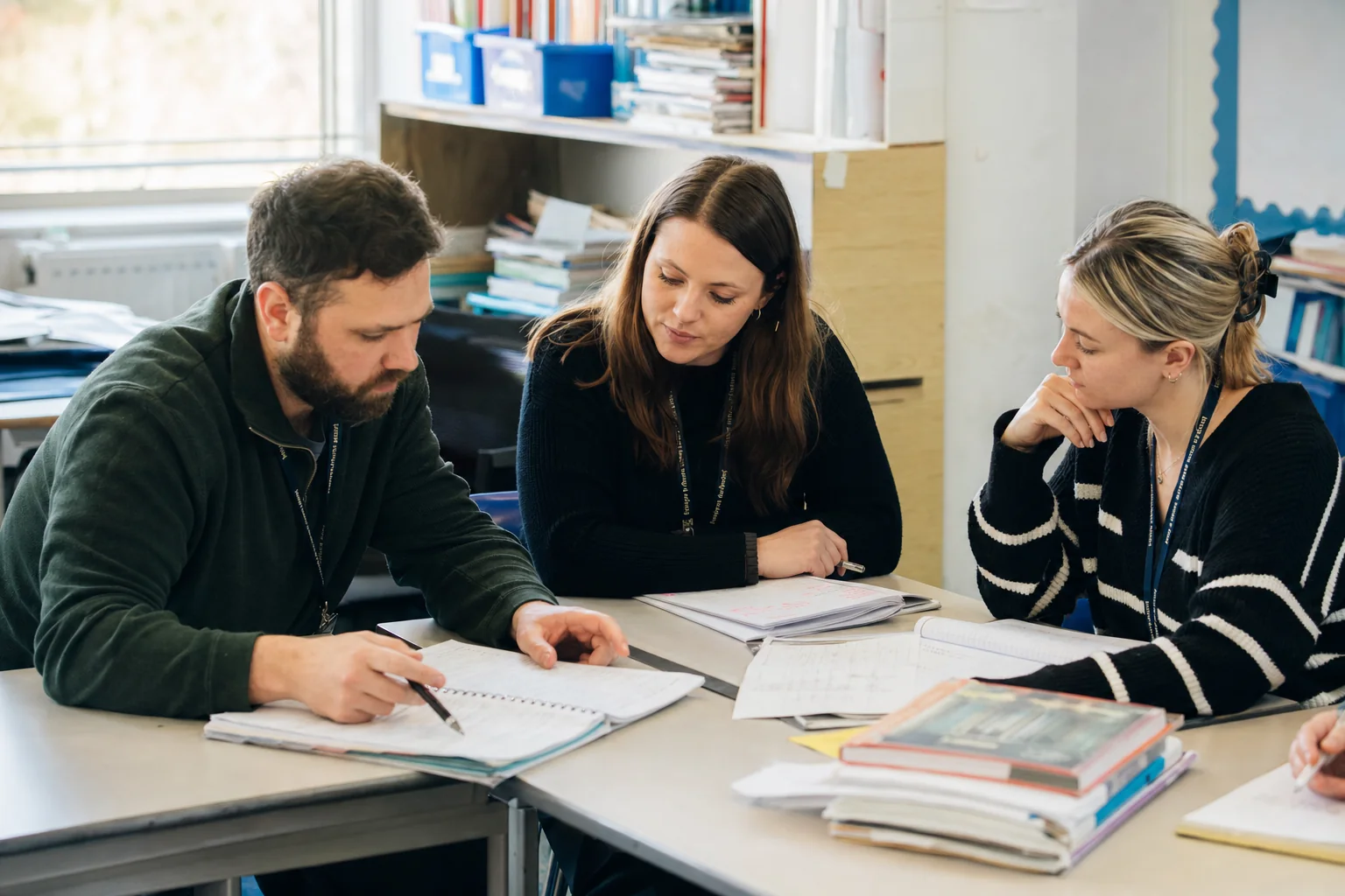 Teachers review curriculum sequencing and lesson flow in a teacher planning setting.
