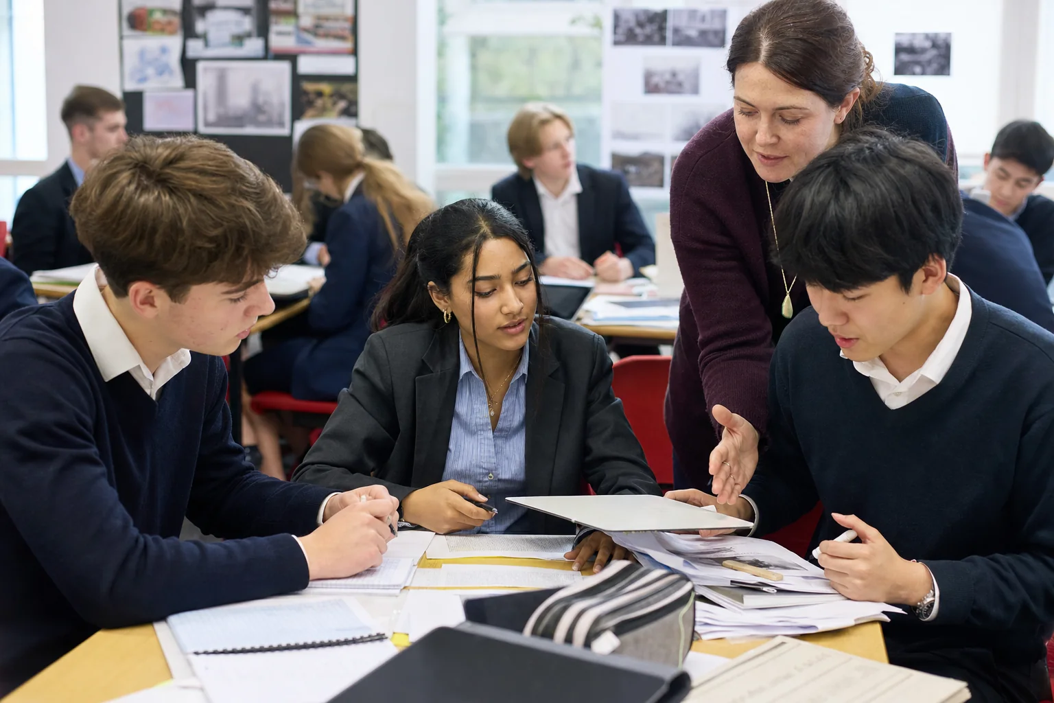 Teacher and learners use source packs and teacher conferencing during Diploma Programme study in an International Baccalaureate classroom.