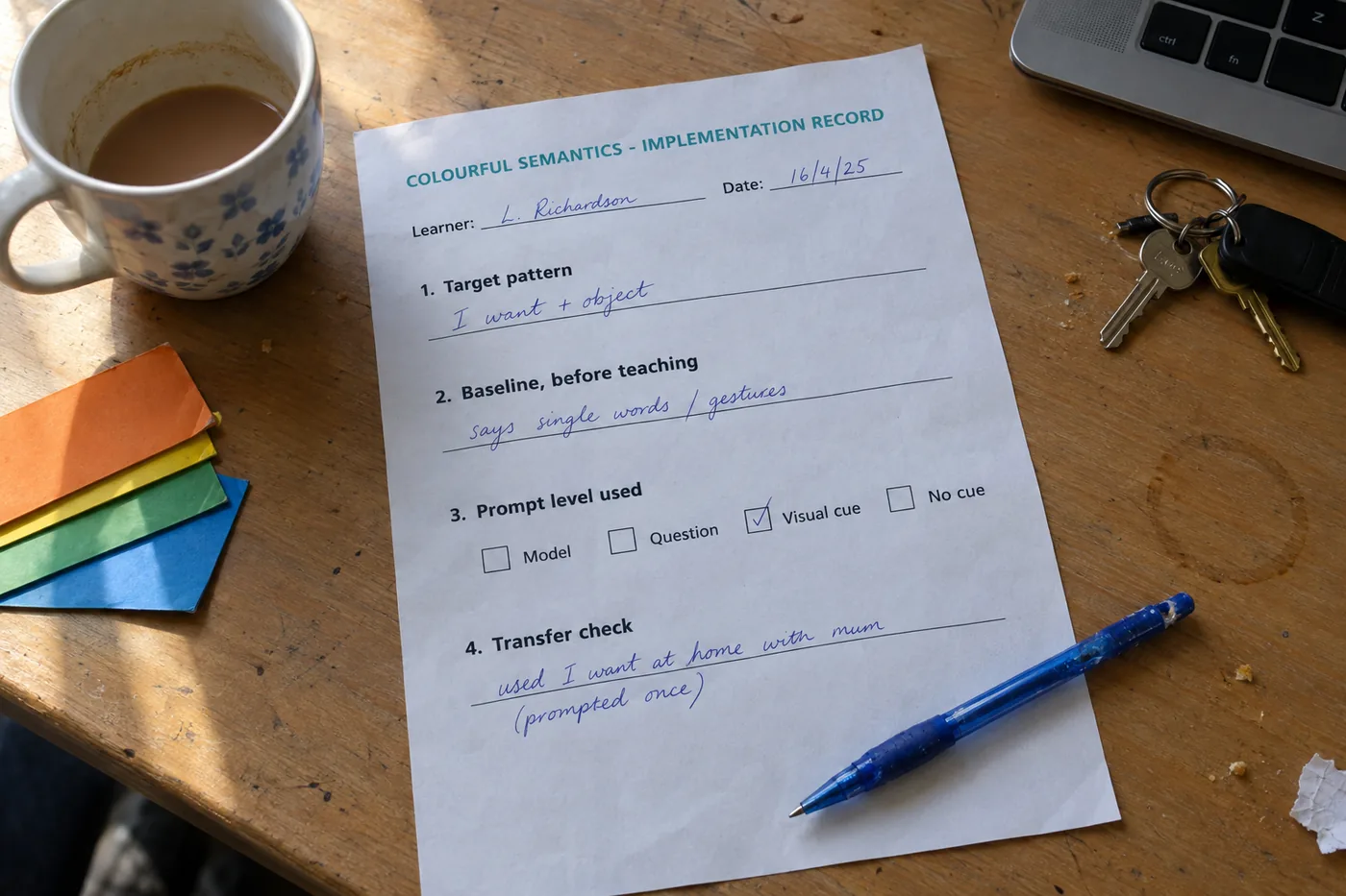 The Colourful Semantics implementation record filled in by hand on a teacher desk, showing the target pattern, the baseline, a ticked prompt level and a transfer check