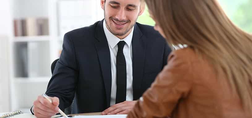 advisor sitting down and talking to his client