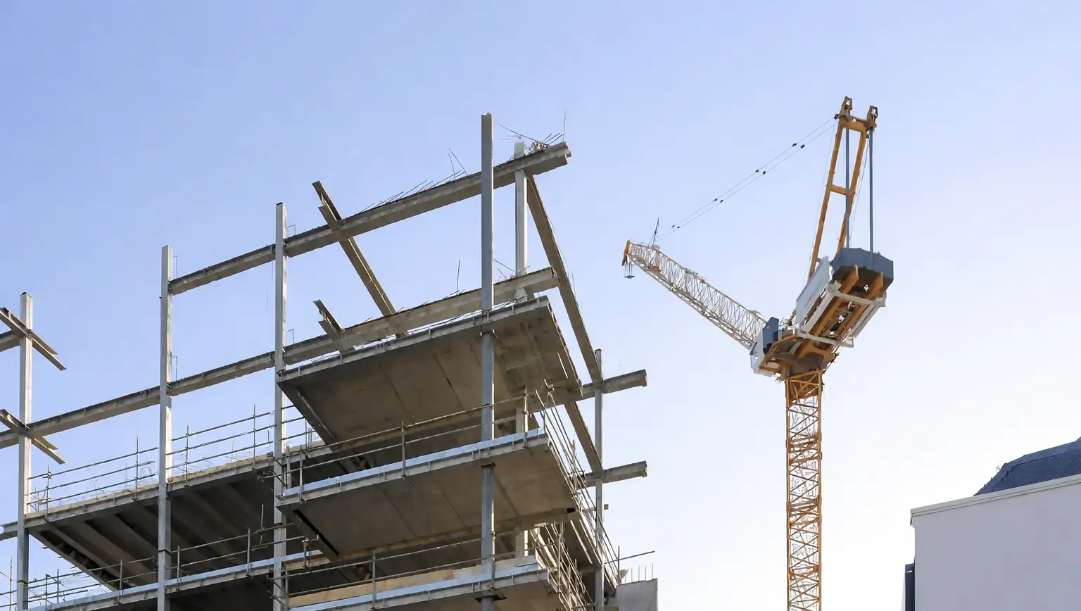 Building under construction with a crane next to it