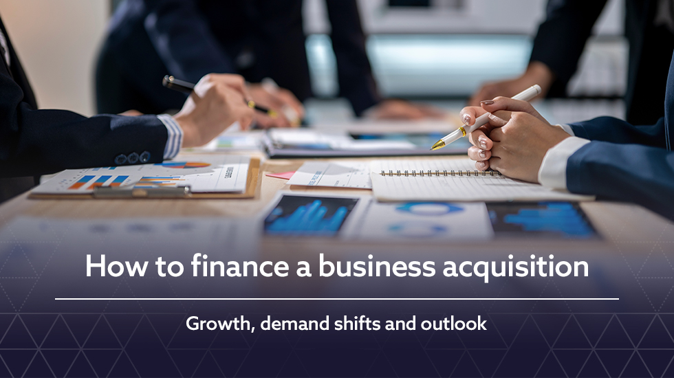 Banner image showing professionals reviewing financial charts and documents in a meeting.
