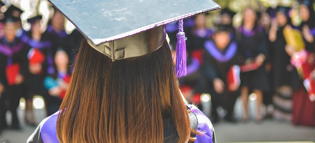 A close-up image of a person wearing graduation cap