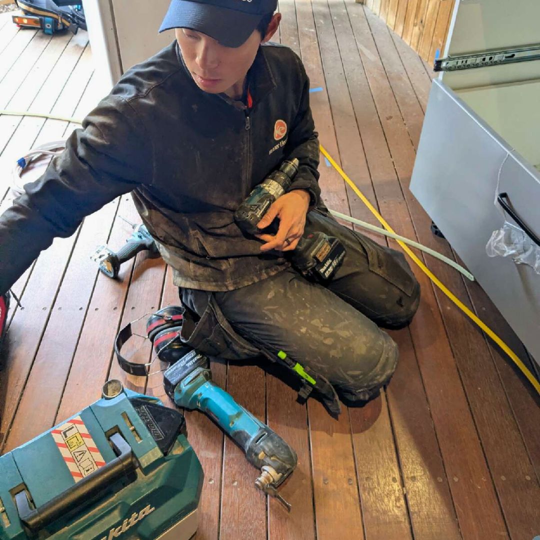 Kenner electrician working on Greg's house to wire in electric oven