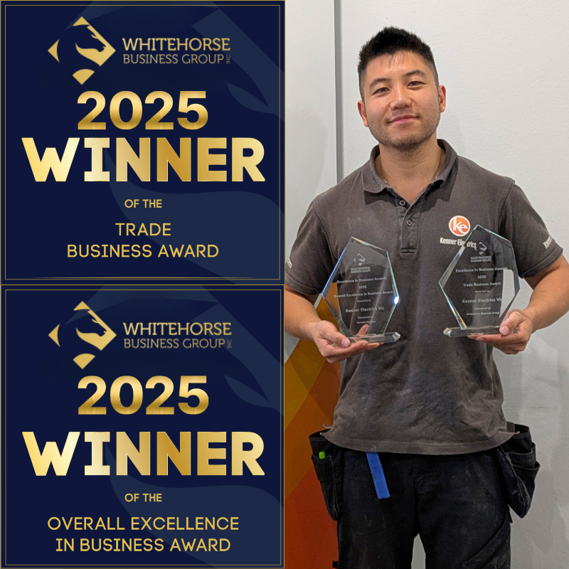 Kenner Electrician smiling and holding 2 Whitehorse Business Excellence Awards they just won