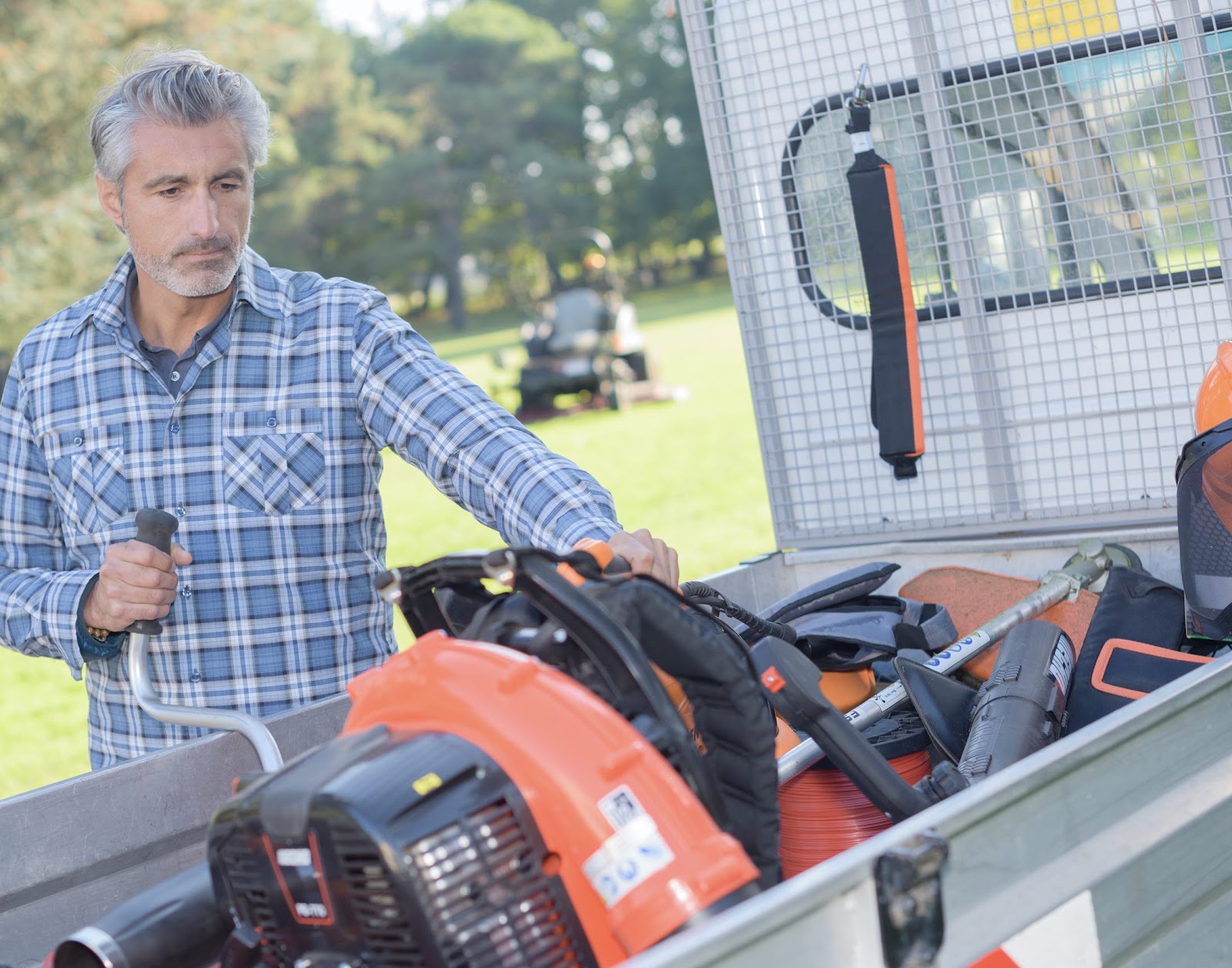 man-inspecting-landscaping-equipment