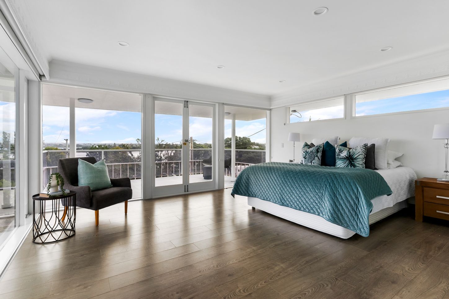 Stanley Pt Road - master bedroom with floor-to-ceiling windows and balcony view
