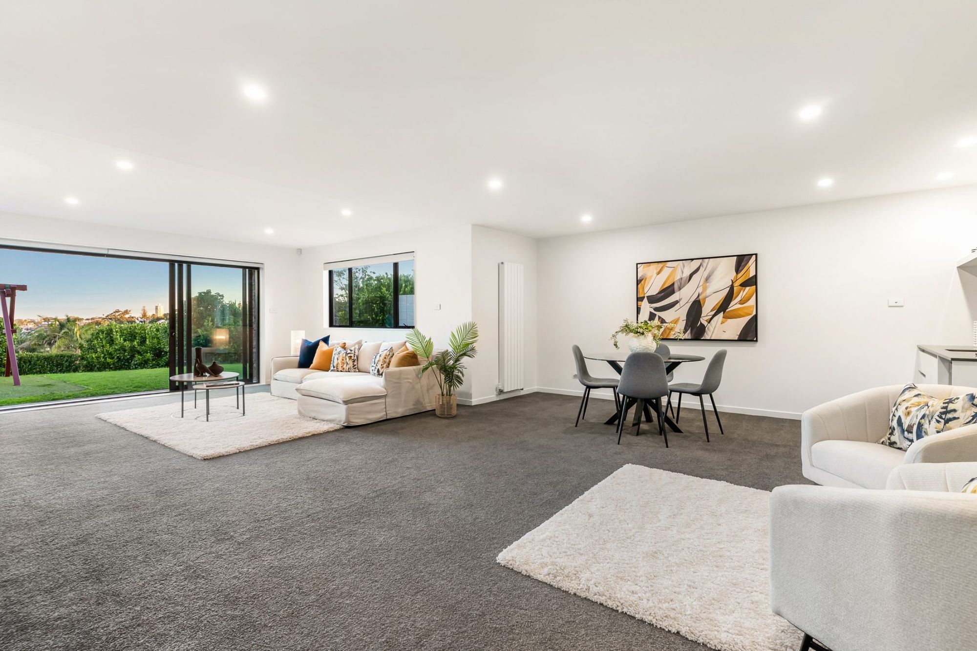 Seaview Road, Castor Bay - white lounge with statement art and bifolds