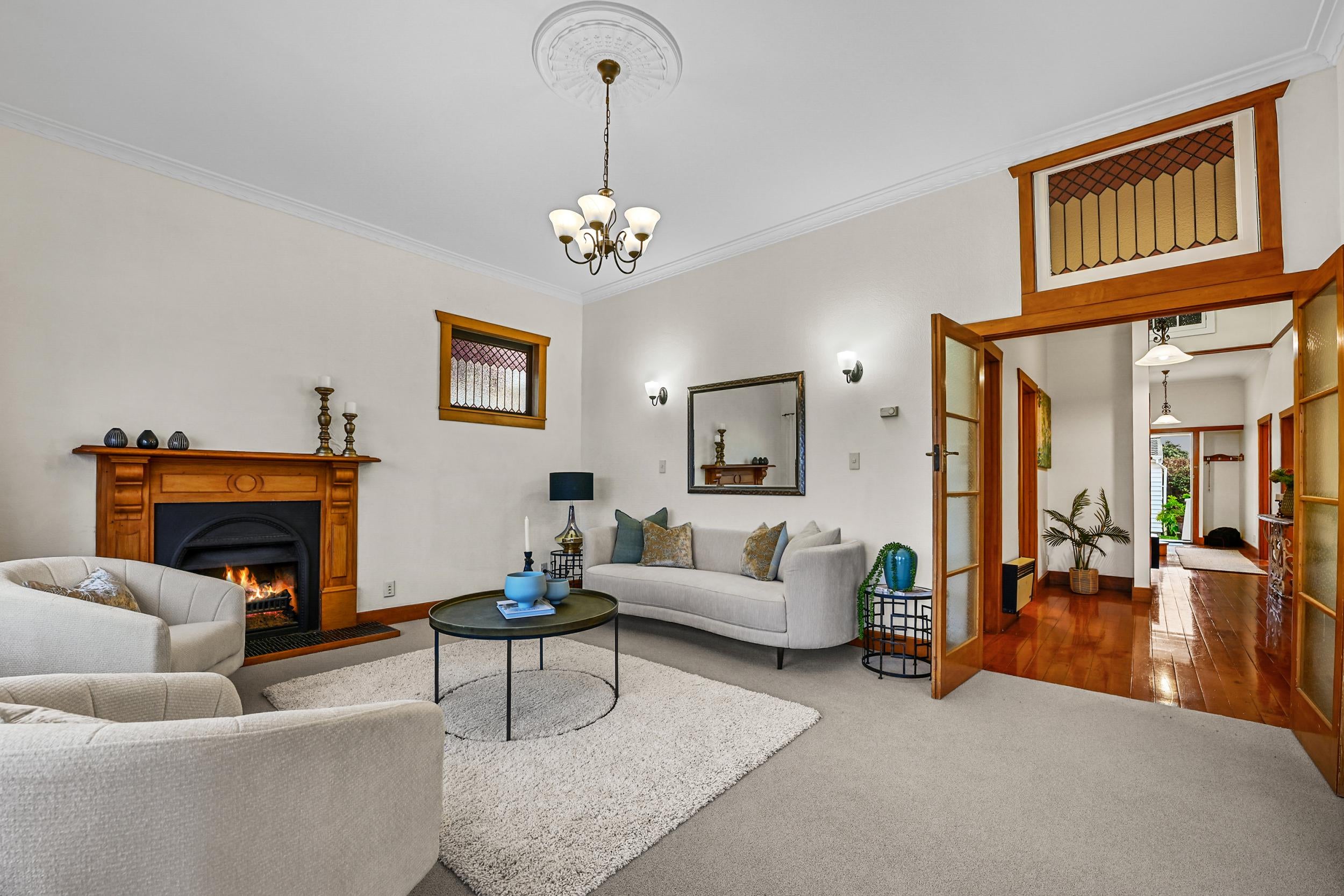 59 Clarence Street, Devonport - lounge with brick fireplace and polished kauri floors