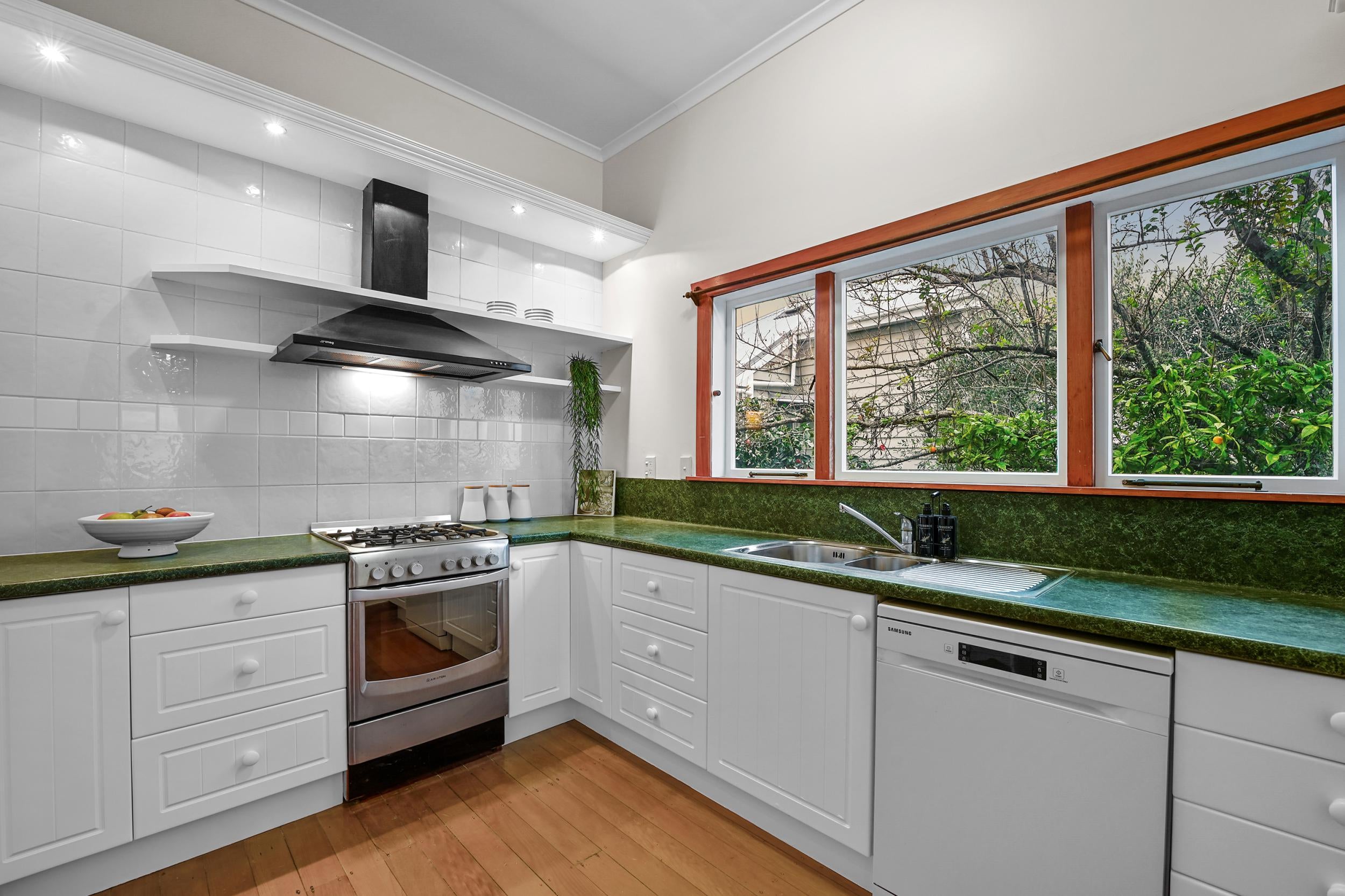 59 Clarence Street, Devonport - kitchen with stainless appliances and green benchtop