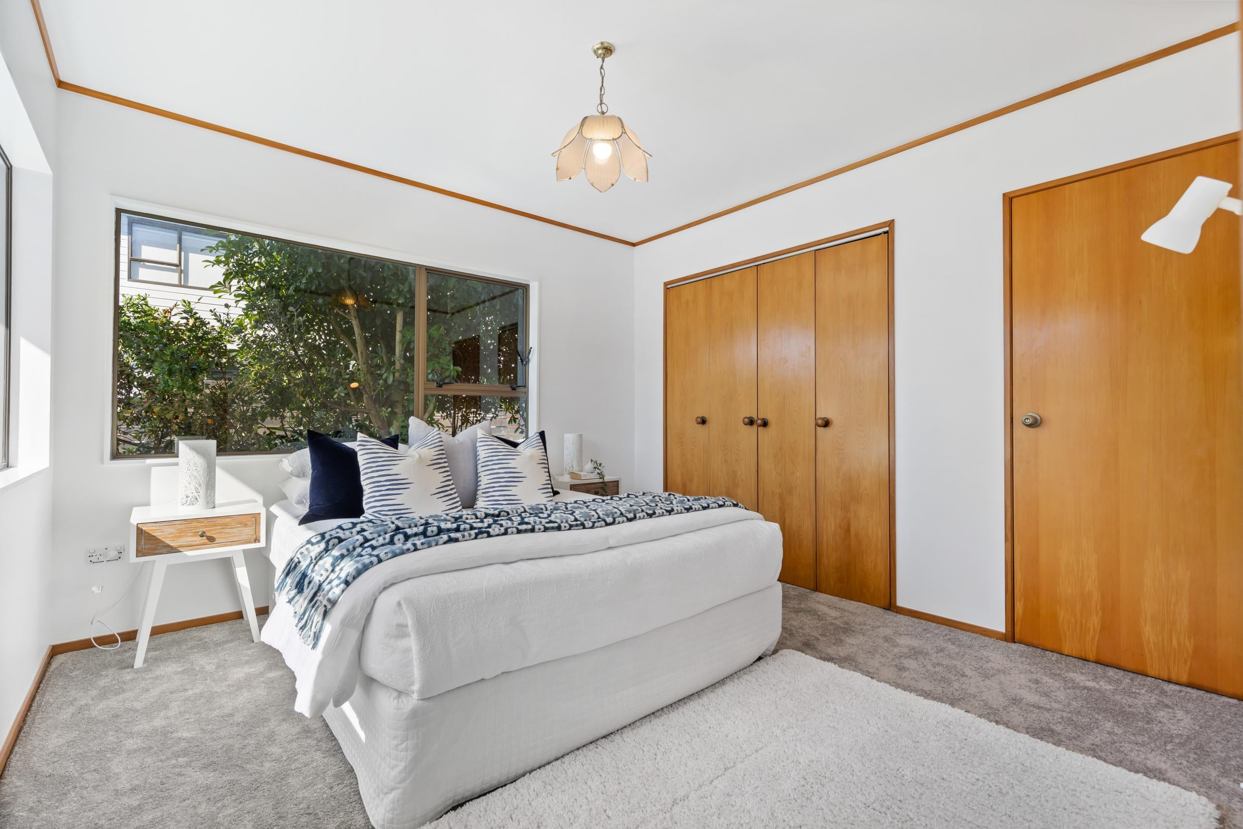 Churchill Road, Murrays Bay - third bedroom styled with occasional chair
