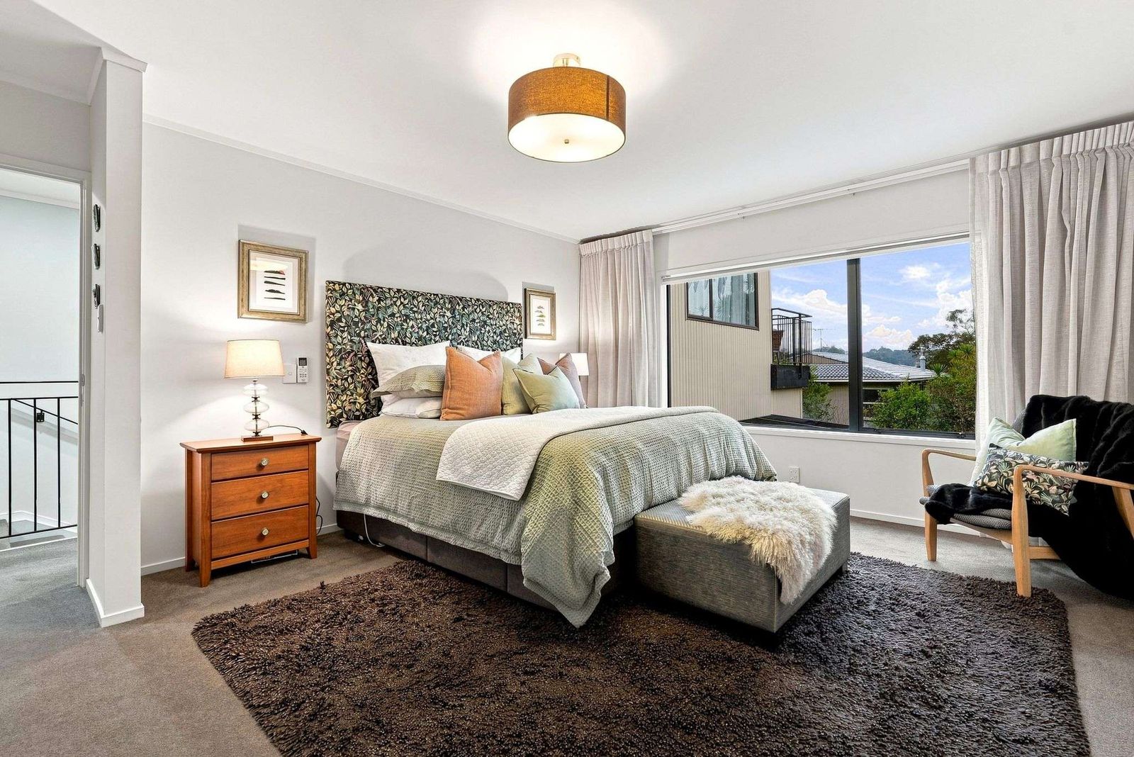 Beach Road, Campbells Bay - main bedroom styled with feature wallpaper
