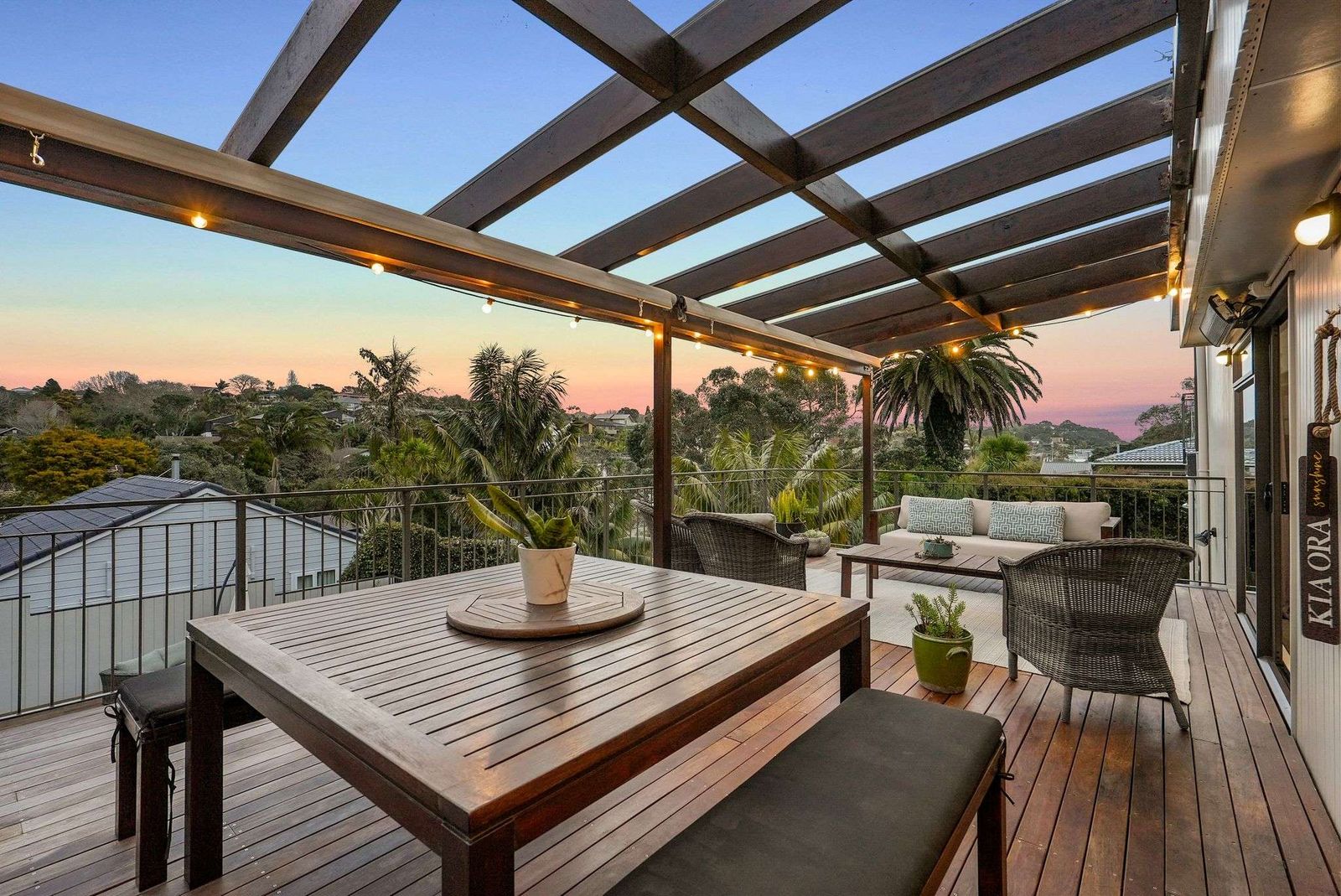 Beach Road, Campbells Bay - covered deck with outdoor dining setting at sunset