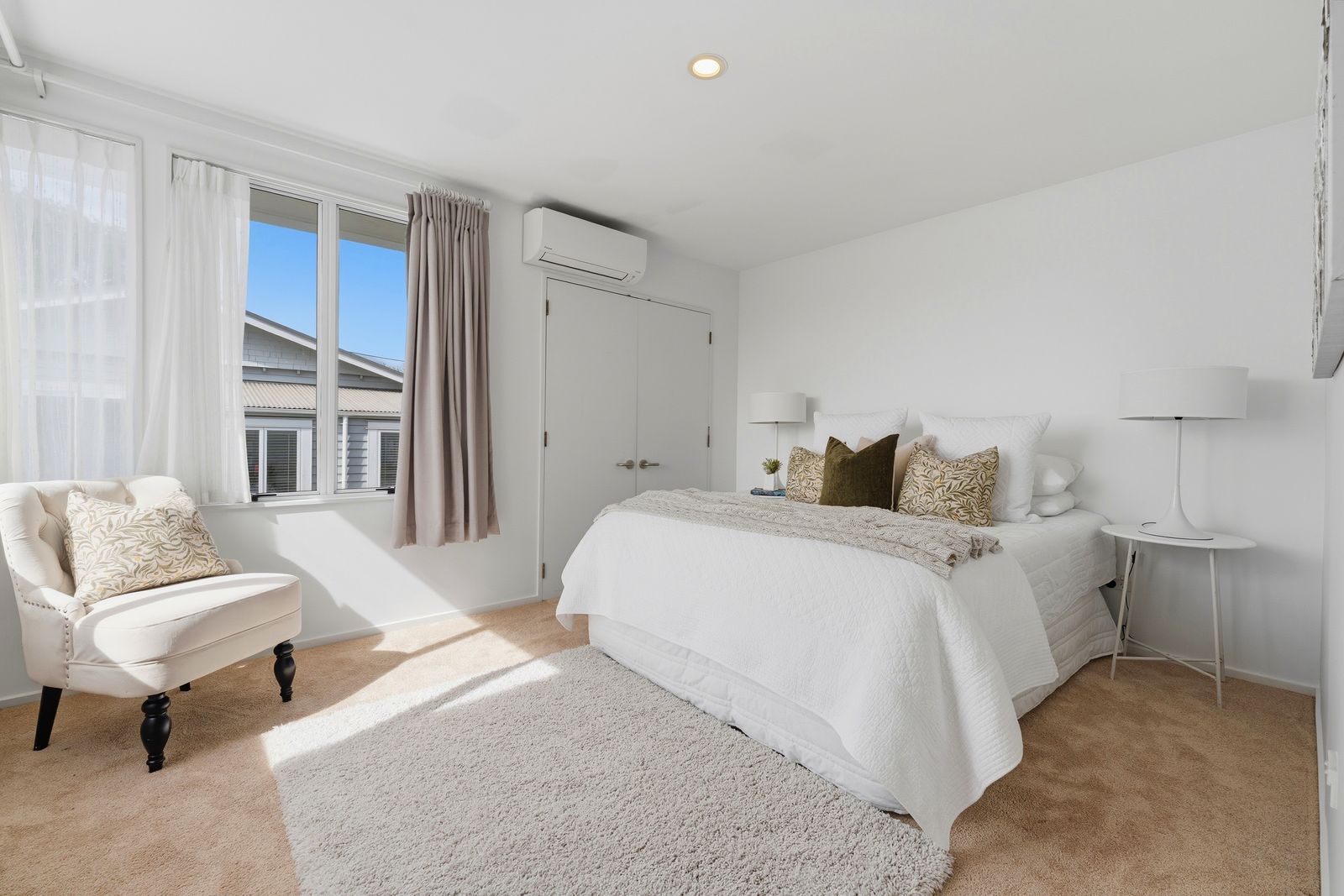 Otakau Road, Milford - bedroom styled in crisp whites