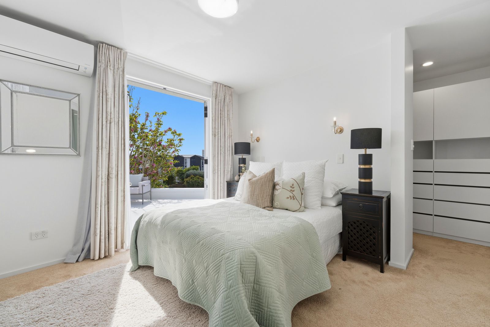 Otakau Road, Milford - main bedroom styled in soft greens