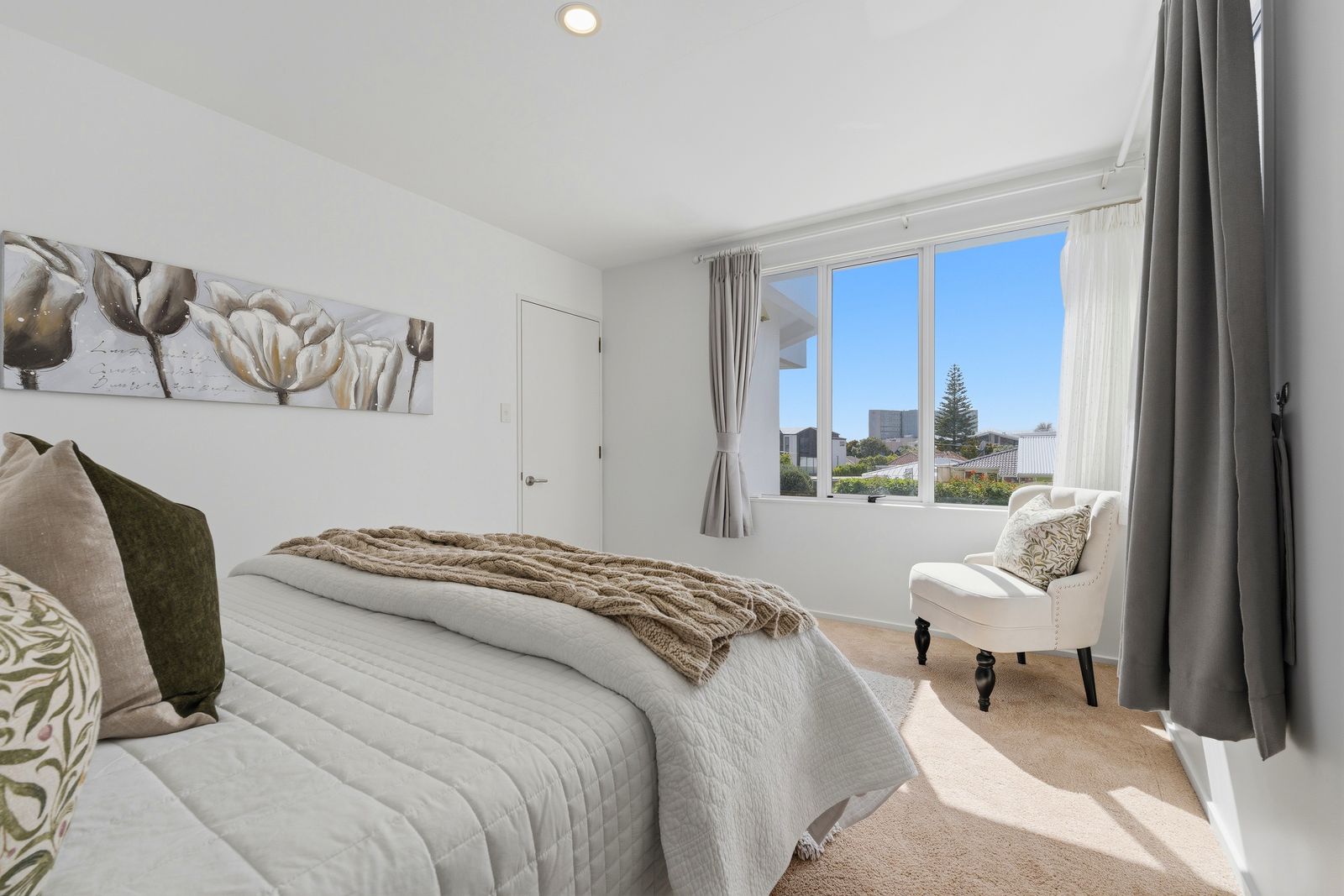 Otakau Road, Milford - bedroom styled with layered cushions