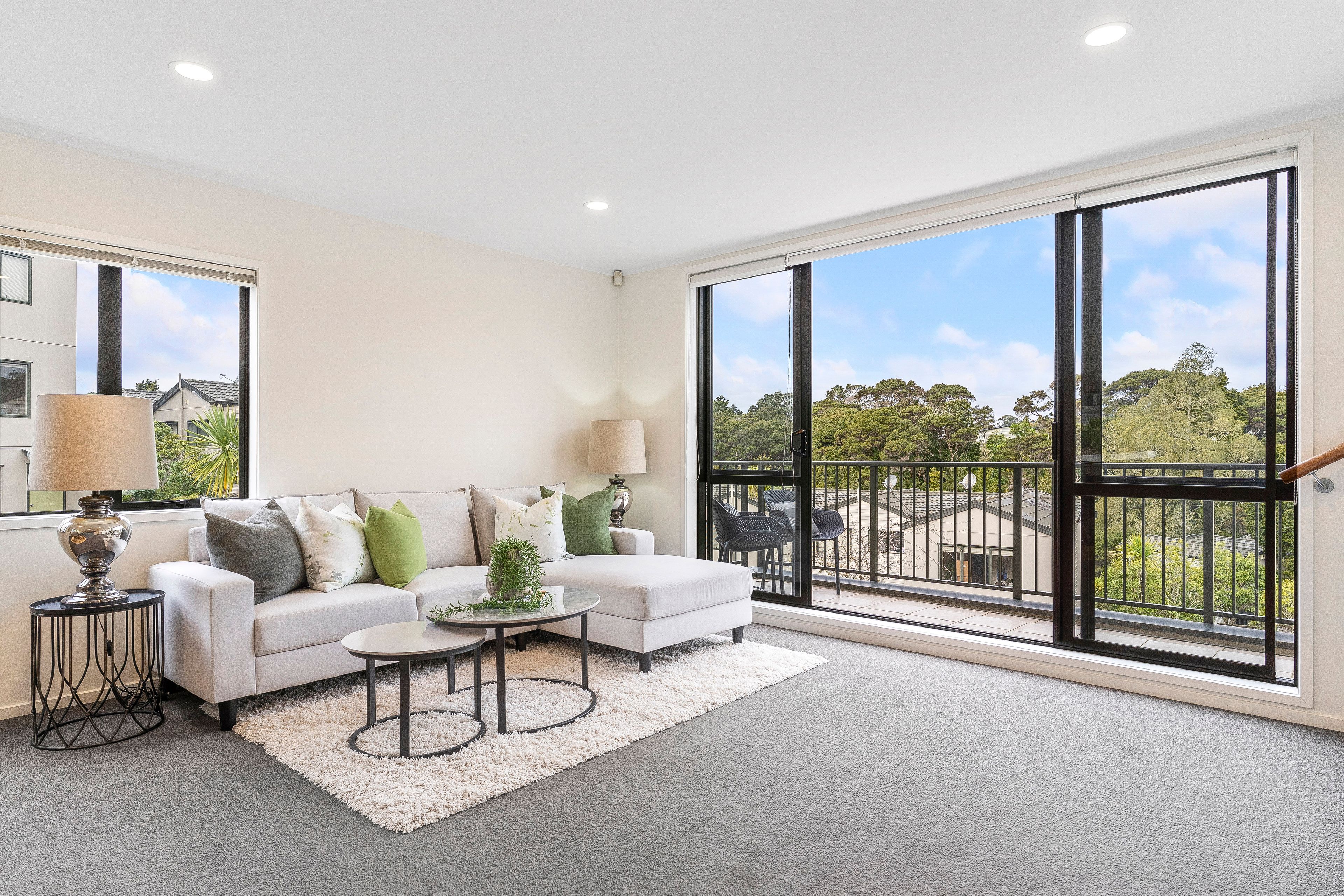 Flynn Street, Birkdale - living room styled to open onto the balcony and treetop outlook