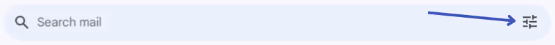A screenshot fo the Gmail search box with a blue arrow pointing to the filter icon at the far right of the search bar 