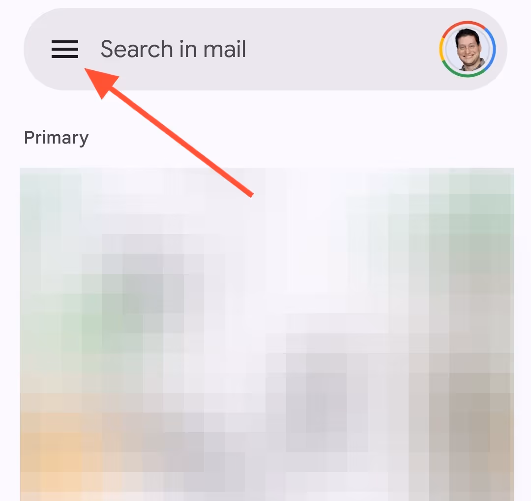 A screenshot of the Gmail inbox using an Android device, where the inbox is blurred out and a red arrow is pointing to the three horizontal lines