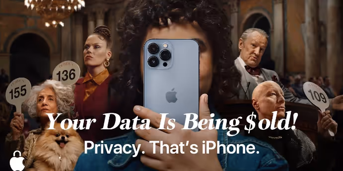 A diverse group of people in a vintage room, bidding with numbered paddles, focusing on a large iphone with text overlay saying "your data is being $old! privacy. that’s iphone.