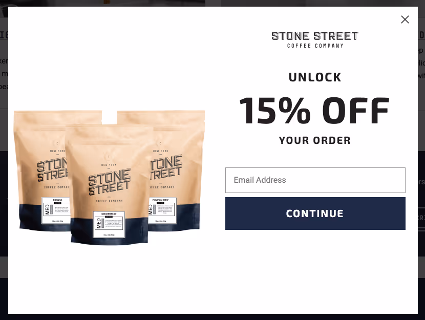 Promotional image for Stone Street Coffee Company, showcasing three "Stone Street" coffee bags on the left. On the right, a lead generation form offers 15% off with a field to enter your email address and a "Continue" button.