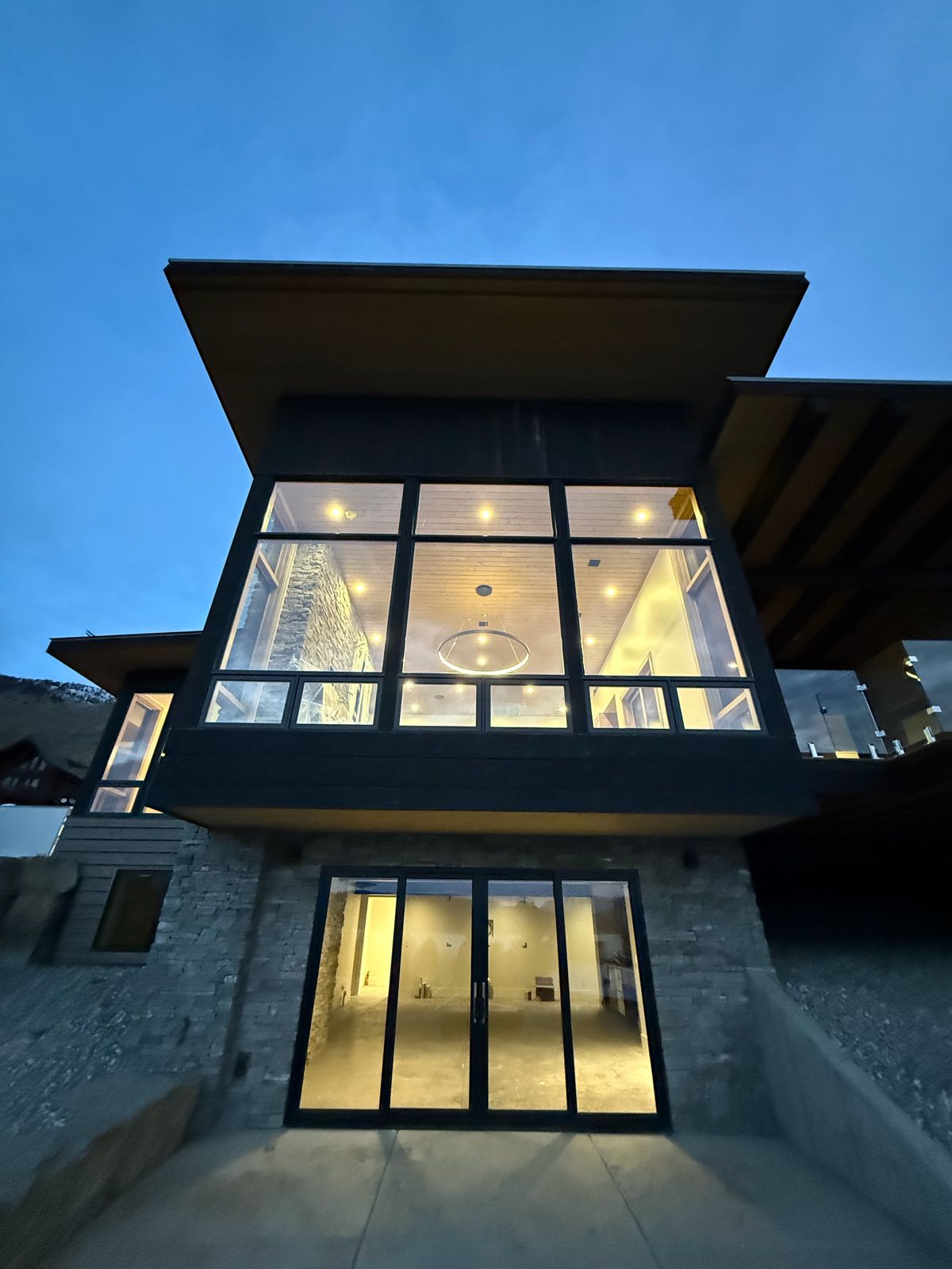 Modern home glowing at dusk with freshly cleaned windows