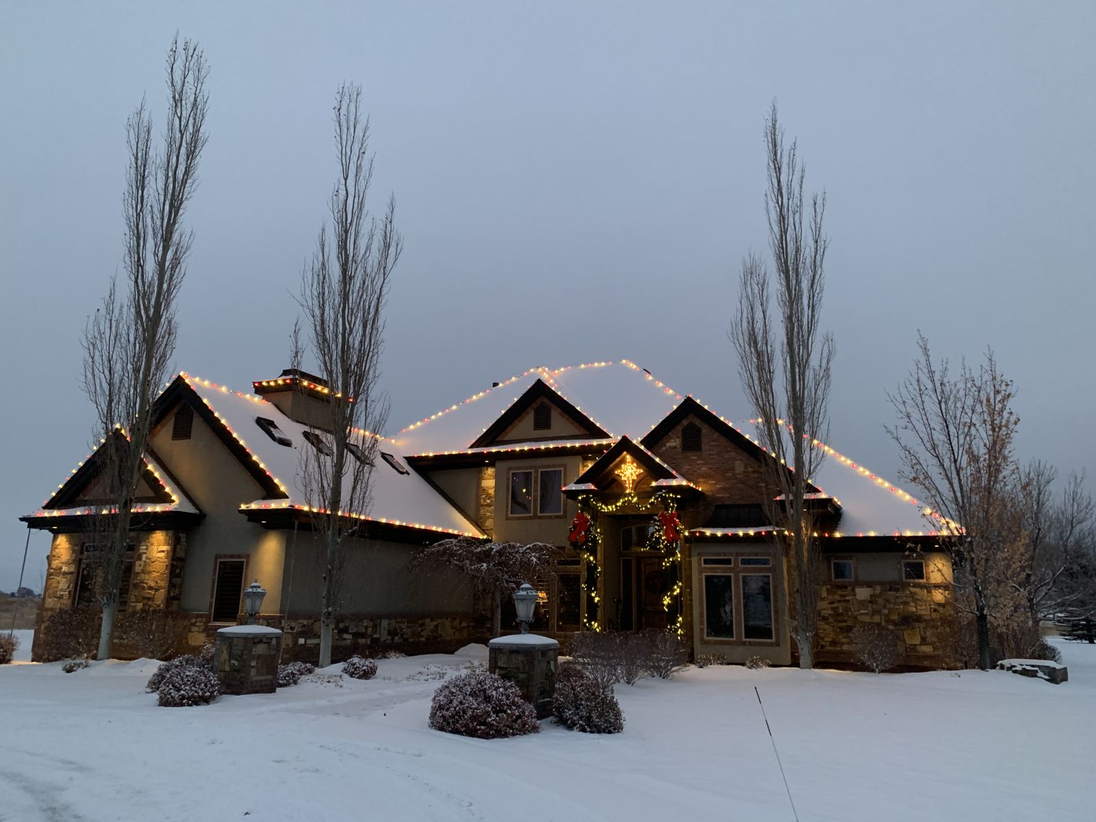 Log and stone cabin-style home in fresh snow