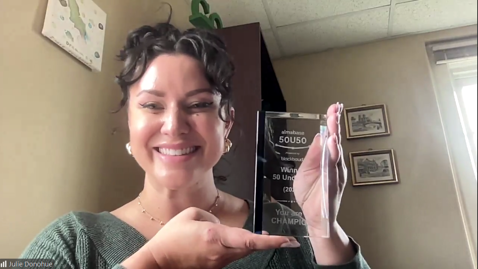 Julie posing with her 50U50 trophy