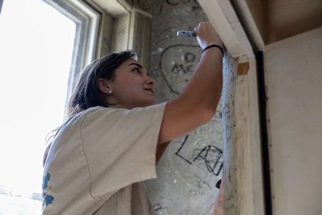A senior signing the Ventress Hall turret for a memorable moment.