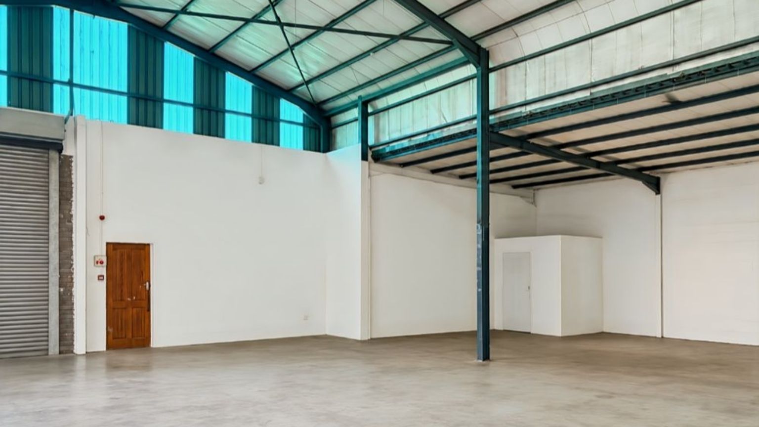 Secure warehouse with roller shutter door and truck access