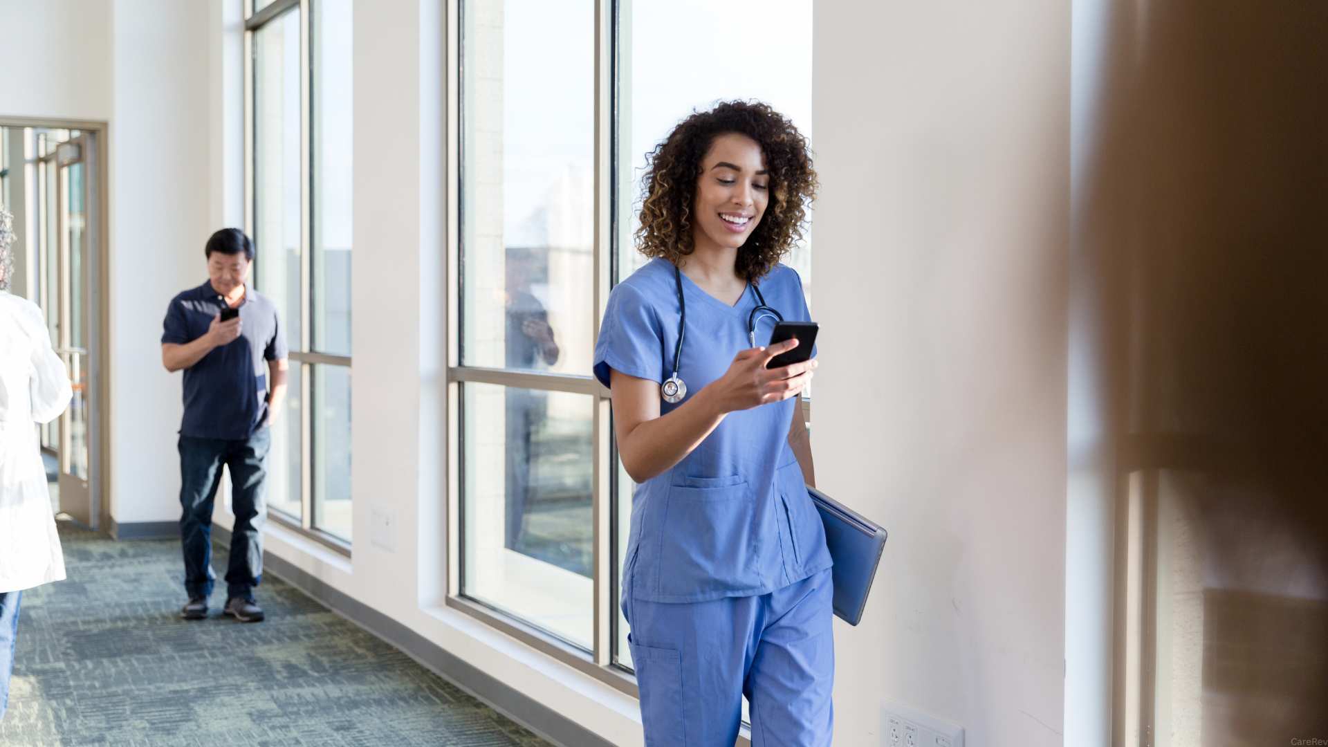 A Texas nurse checks her phone as she walks while on a break.