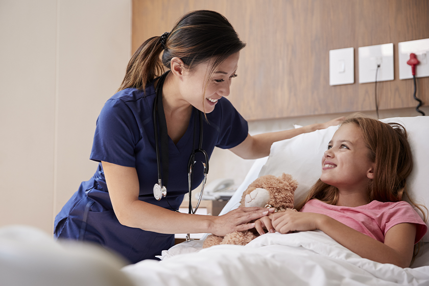 Nurse taking care of a patient at bedside