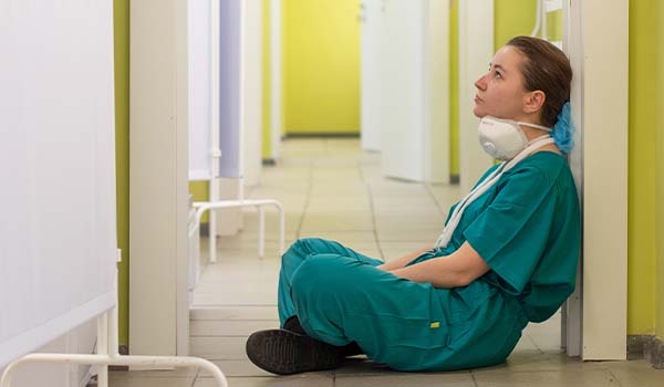 burnt out nurse working overtime