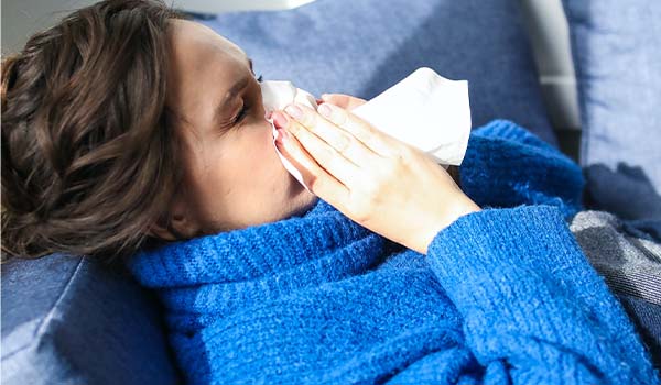 nurse blowing nose during flu season