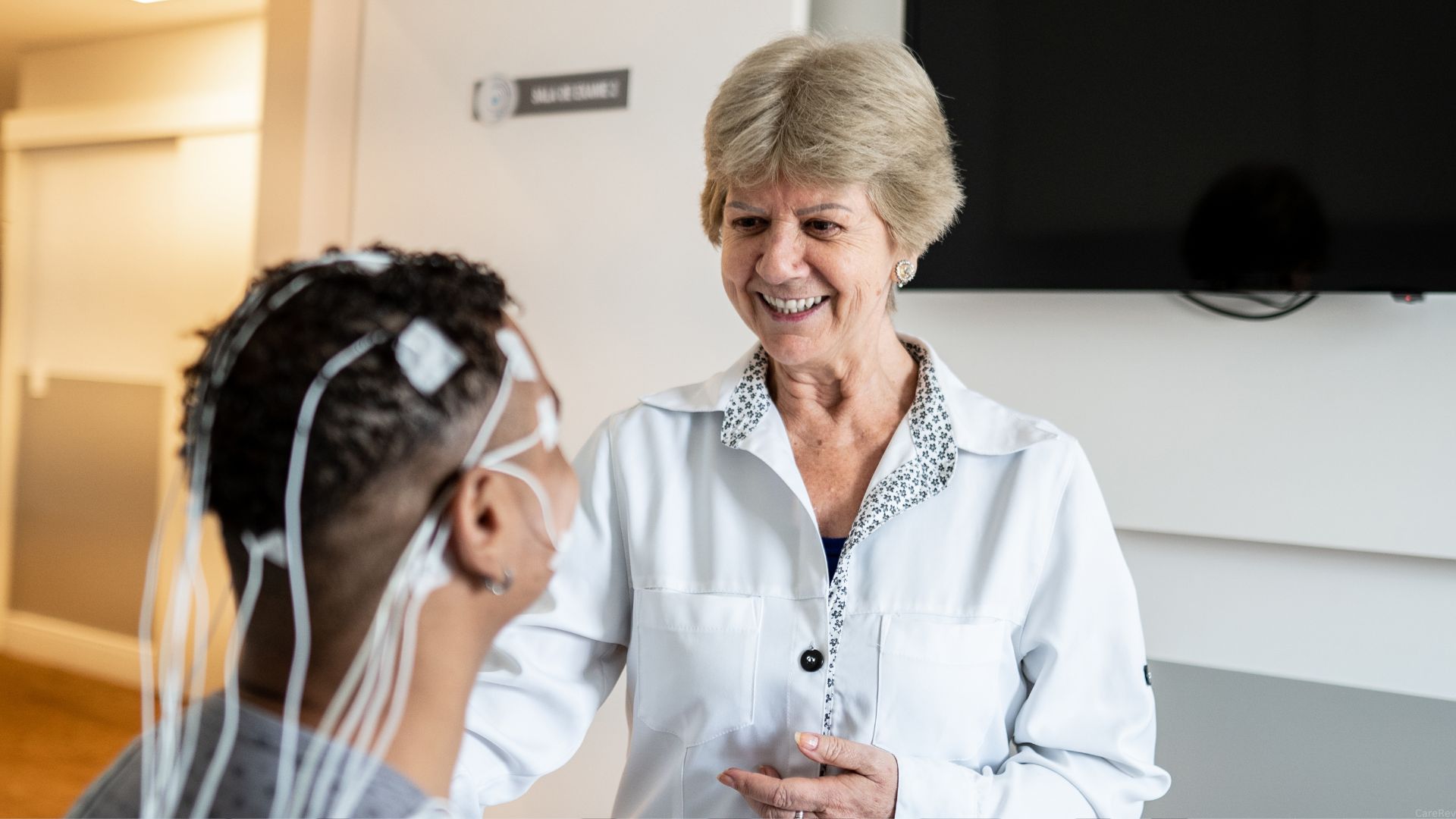 A somnologist prepares a sleep test on a patient.