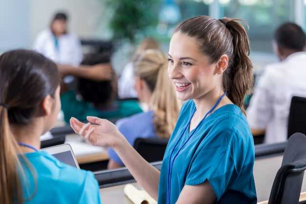 A CNA student speaks to her classmate.