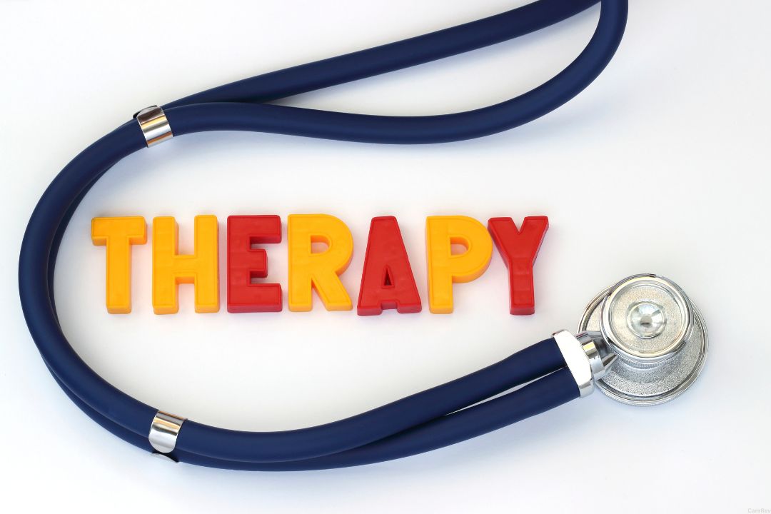 Therapy spelled out in colorful letters and a stethoscope wrapped around the word.