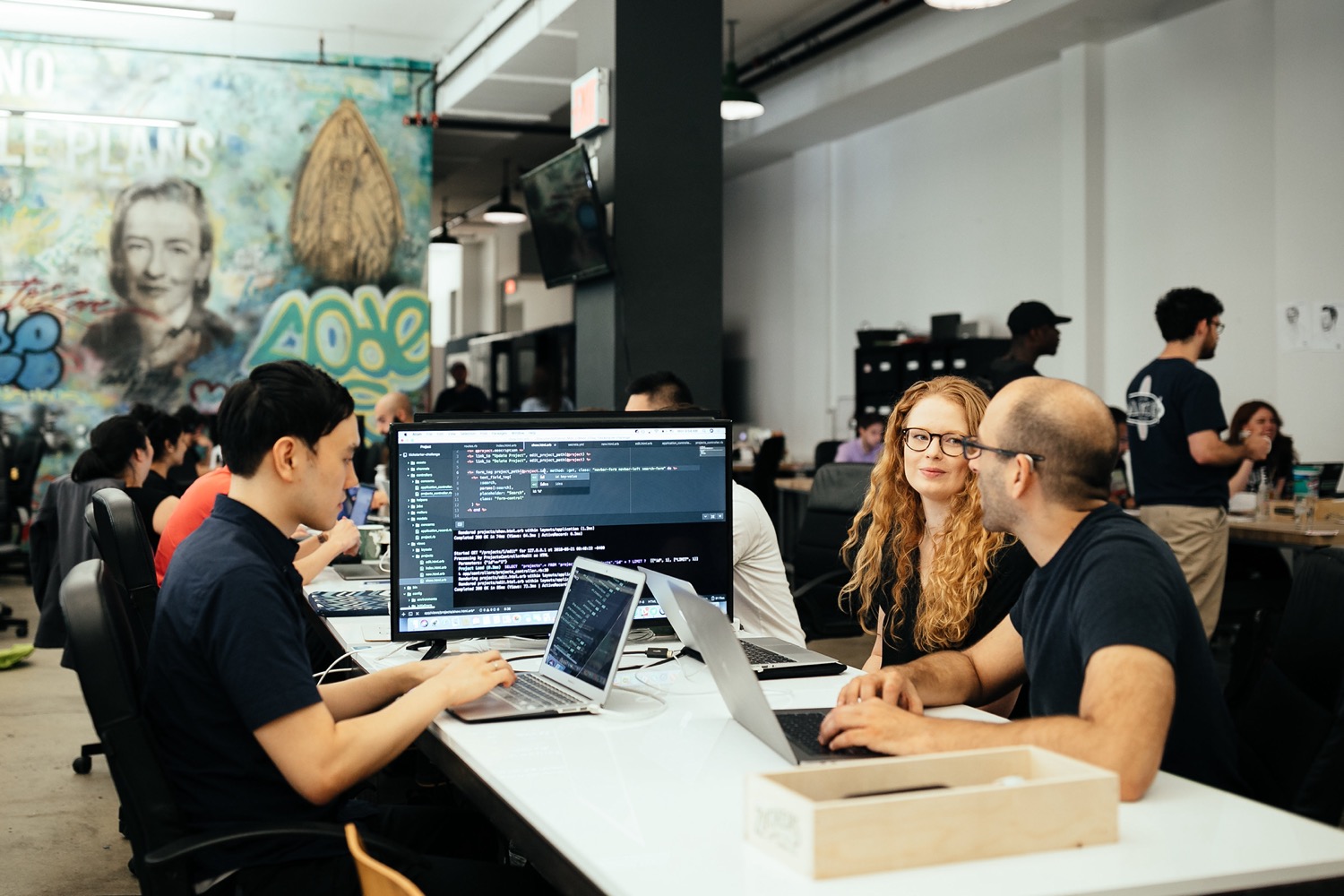An image of people learning together at the Flatiron School