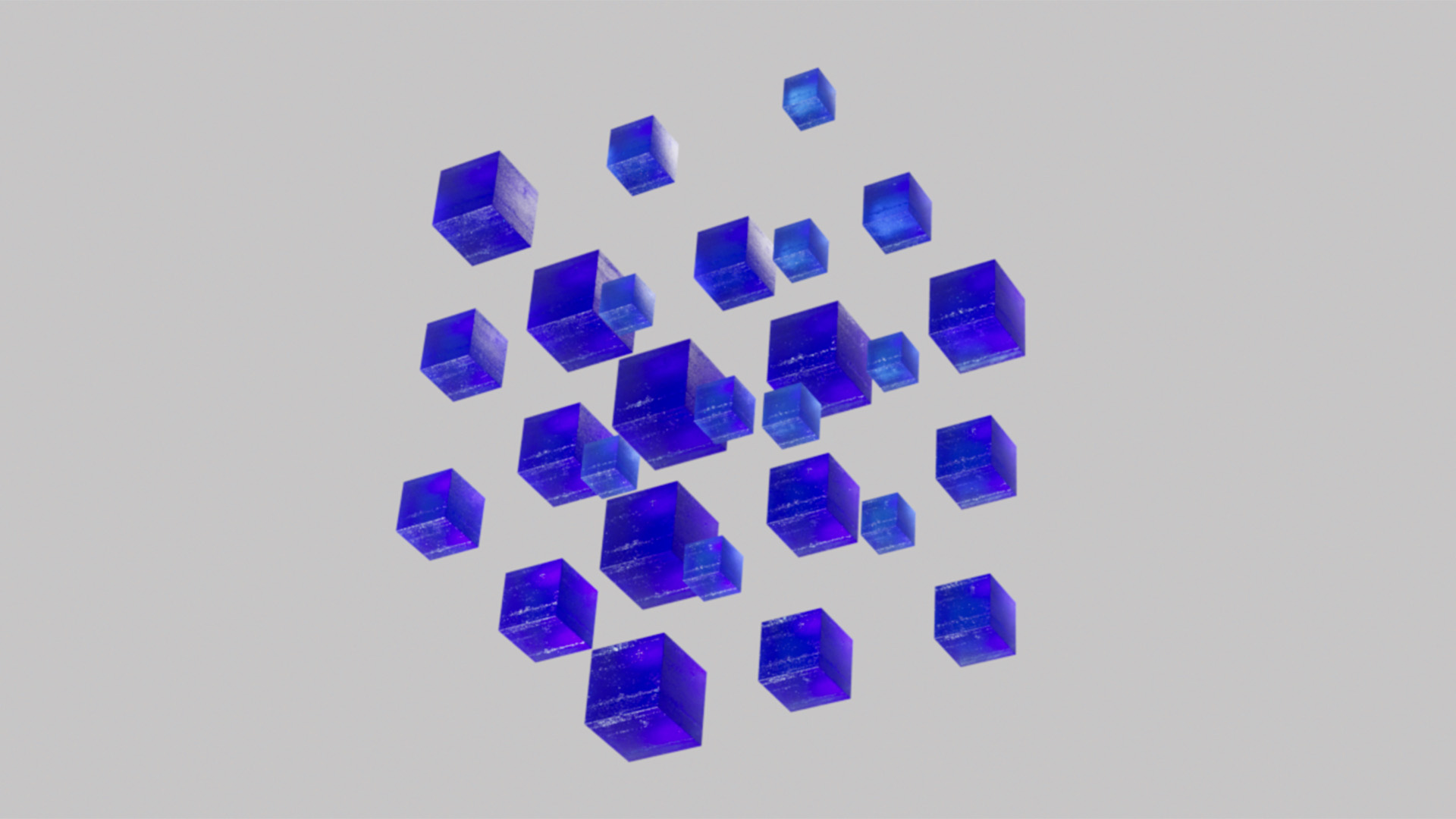 A group of 3D crystal cubes floating in a gray background becoming smaller for the Blauw Films Image Compressor.