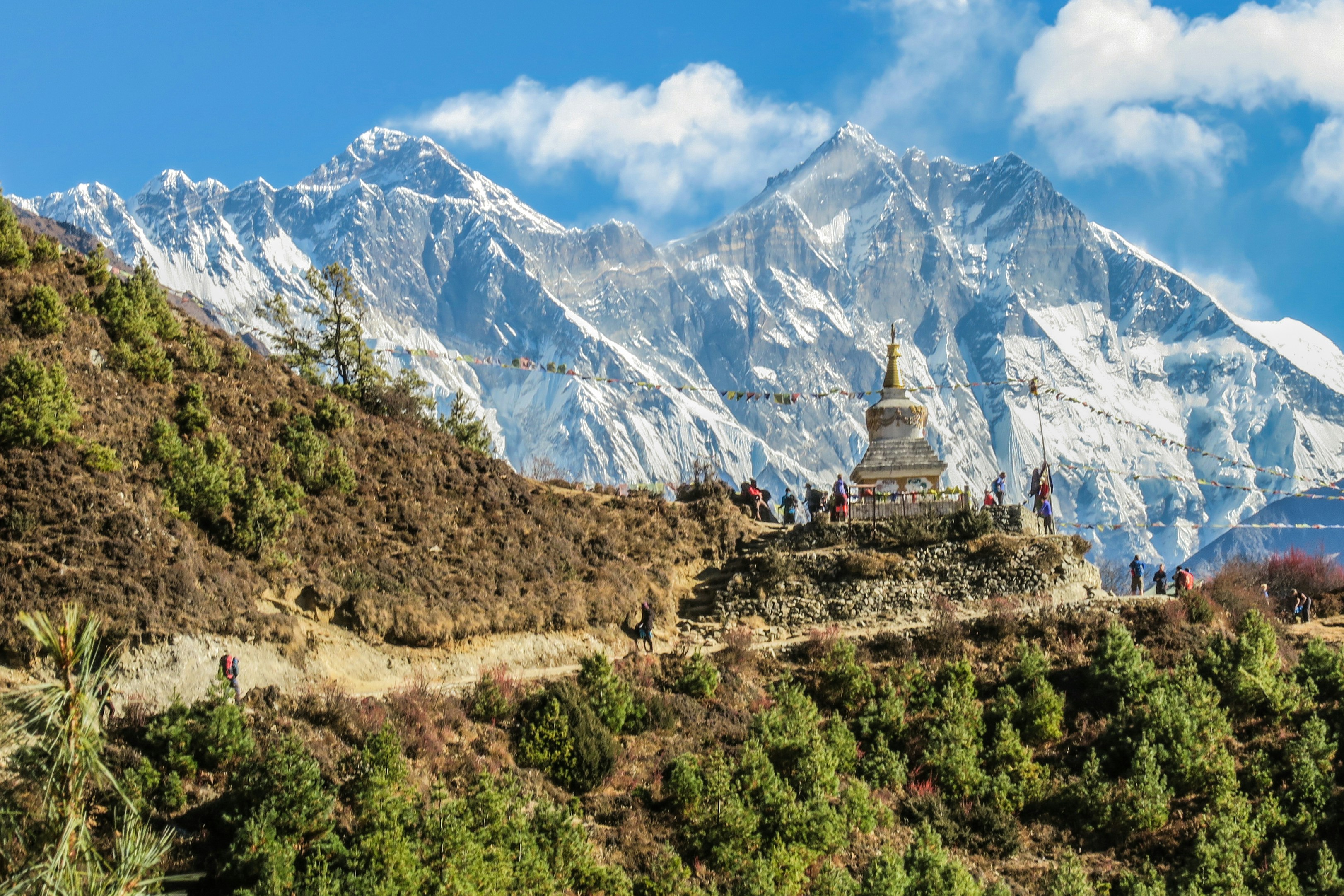 stupa and hikers along an Everest trek.