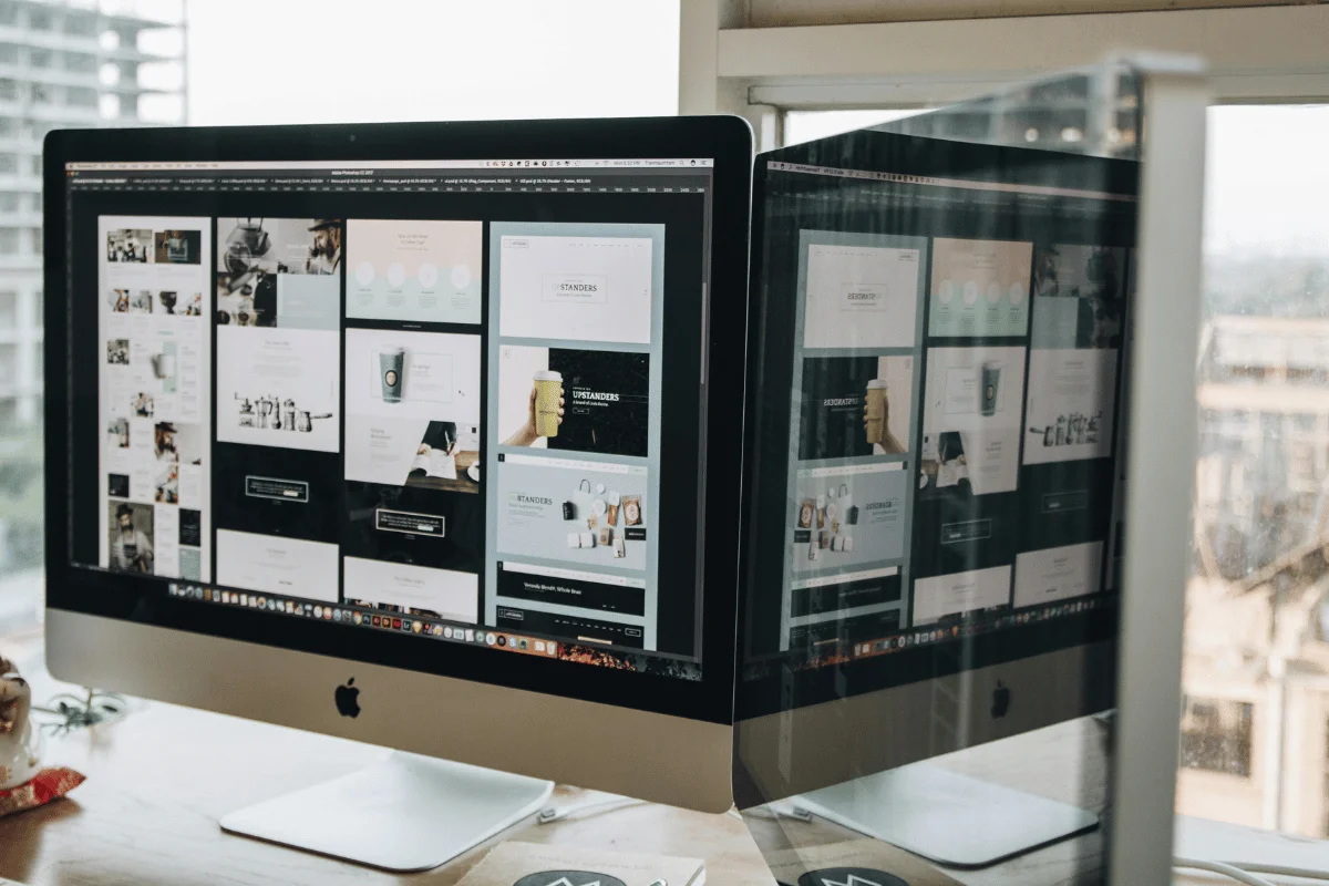 Desktop monitor showing various webpage designs.