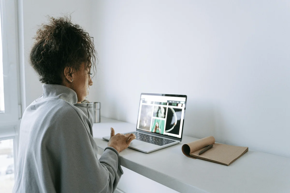 Focused middle-aged female using a laptop in a bright, modern workspace.