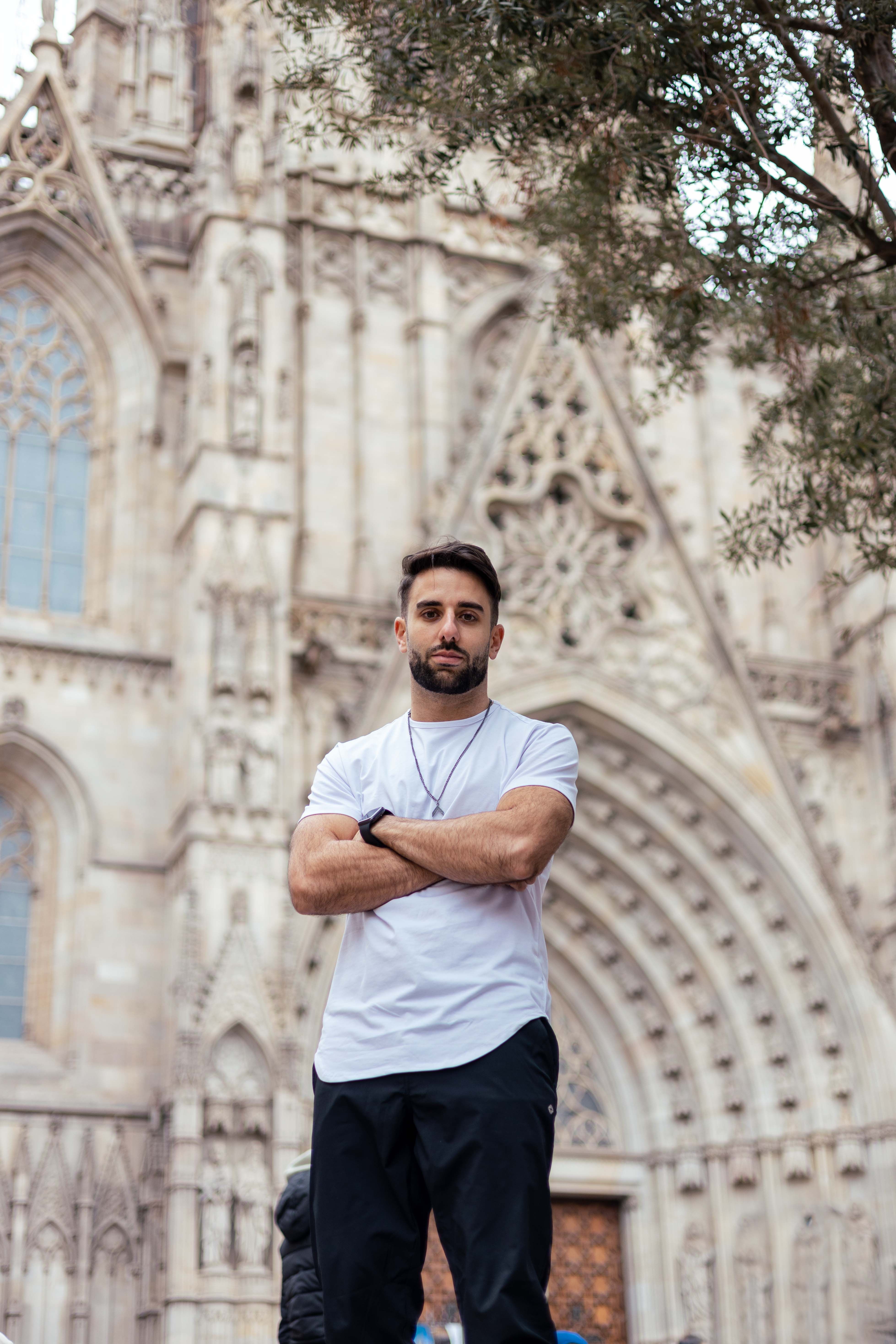 Rhami, CEO of Arch Impact Studio, standing in front of a cathedral, ready to help your mission.