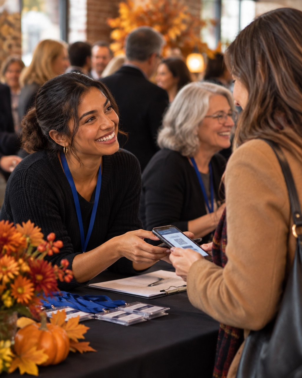 A volunteer welcomes arriving guests at a nonprofit fundraiser check-in