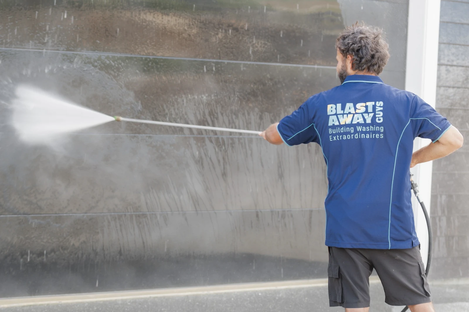 Steve from Blast Away Guys washing a garage door.
