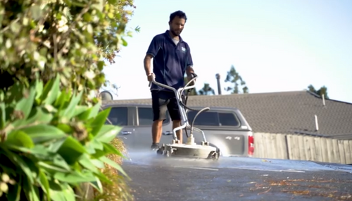 Cleaning concrete paths with water blaster in Whangarei